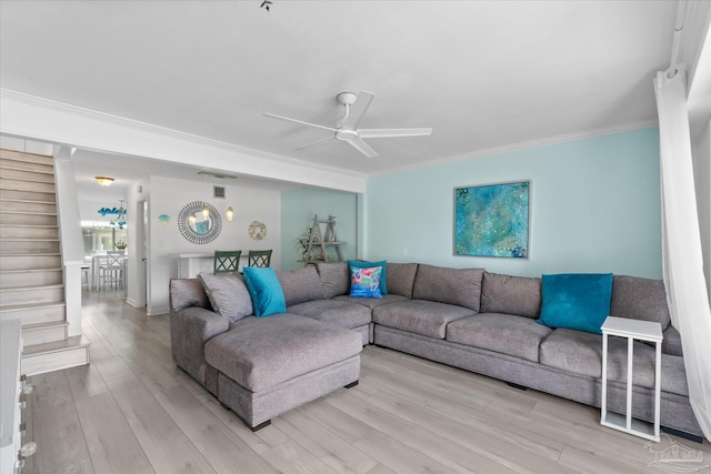 living room featuring ceiling fan, light hardwood / wood-style flooring, and ornamental molding