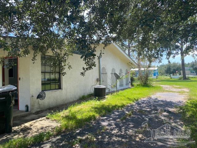 view of side of property with central AC