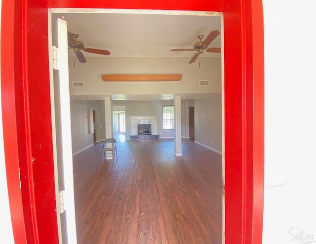 interior space with ceiling fan and dark hardwood / wood-style floors