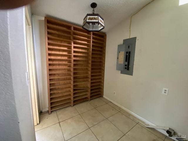 interior space with light tile patterned flooring and electric panel