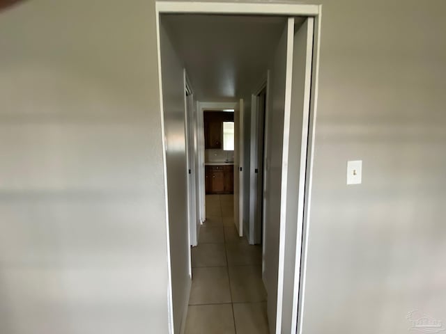 corridor with light tile patterned flooring