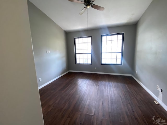 spare room featuring ceiling fan and dark wood-type flooring