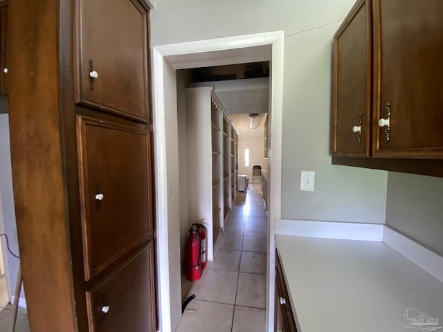 hall with light tile patterned floors