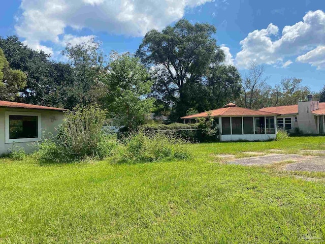 view of yard featuring a sunroom