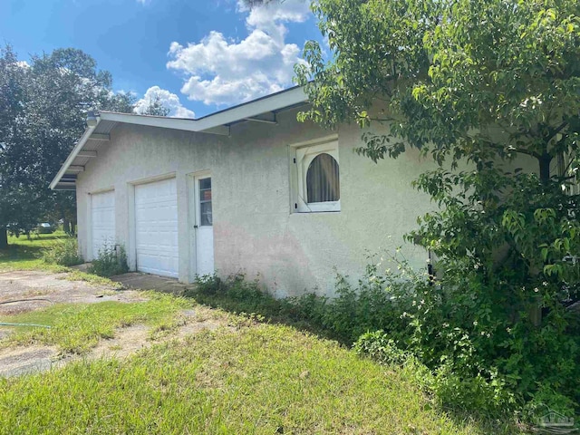 view of side of property with a garage