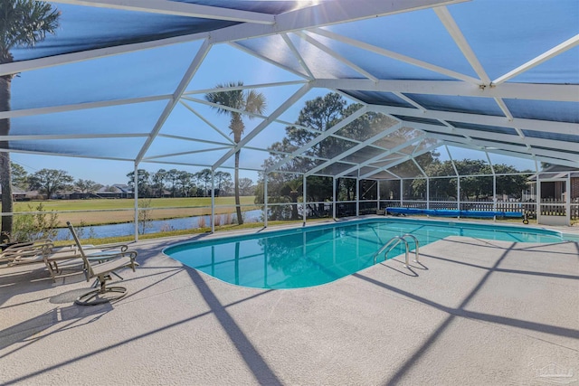 pool with a water view, glass enclosure, and a patio