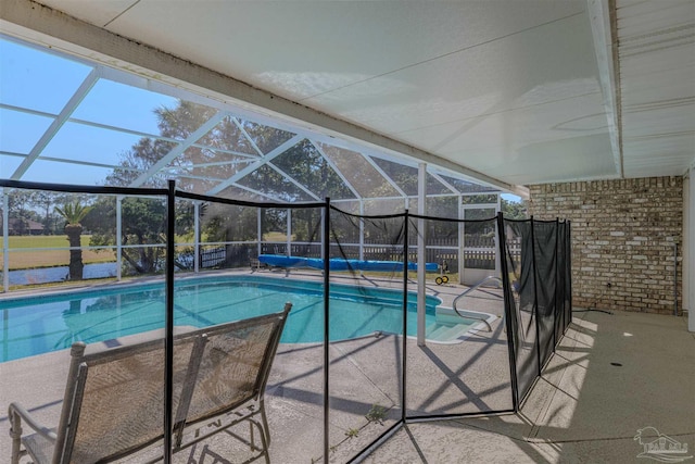 outdoor pool with a patio area and a lanai