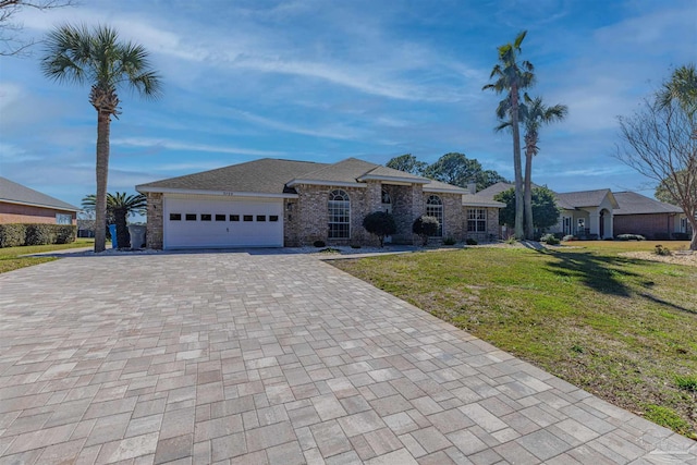 view of front facade featuring decorative driveway, an attached garage, and a front yard