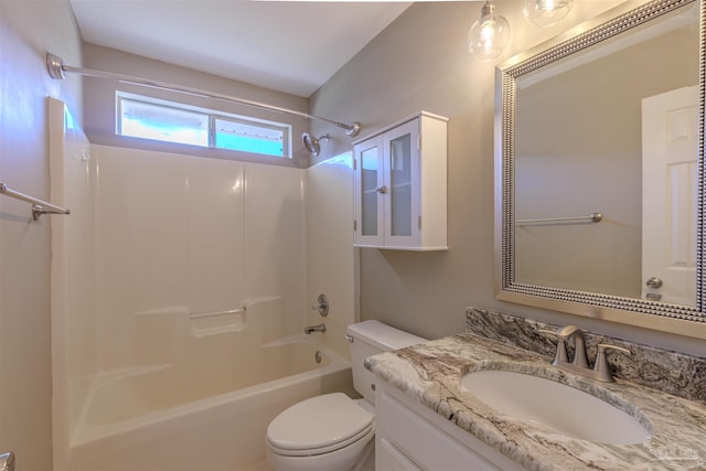 bathroom featuring toilet, shower / bathing tub combination, and vanity