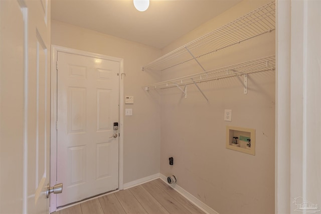 washroom with laundry area, washer hookup, light wood-type flooring, and baseboards