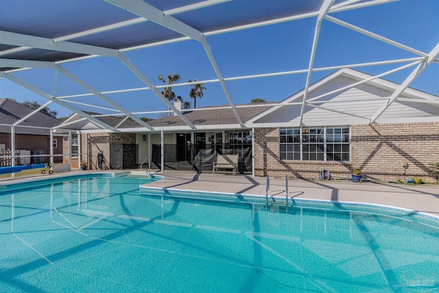 pool with a lanai and a patio