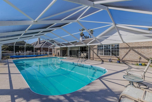 view of swimming pool featuring a fenced in pool, a lanai, fence, and a patio