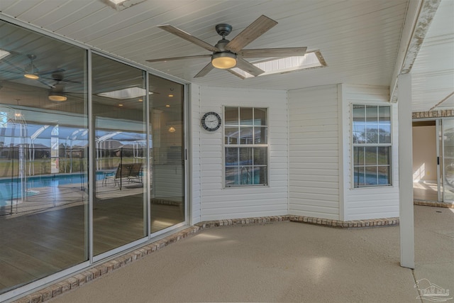 view of patio with ceiling fan and an outdoor pool