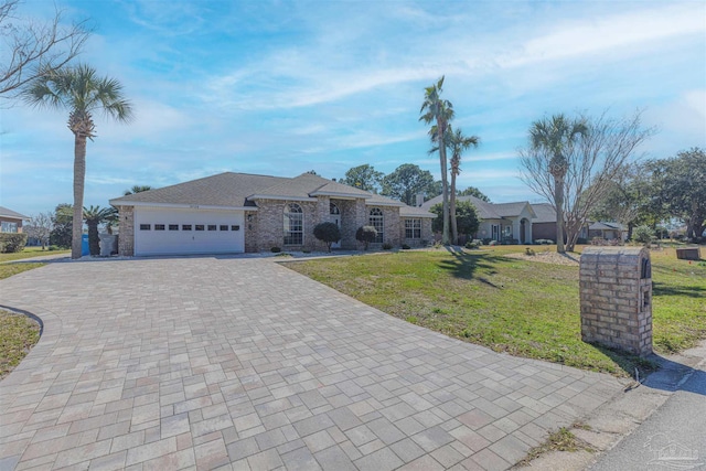 view of front of house with a front lawn, a residential view, decorative driveway, and an attached garage