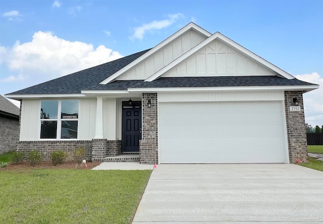 view of front of house with a front yard and a garage