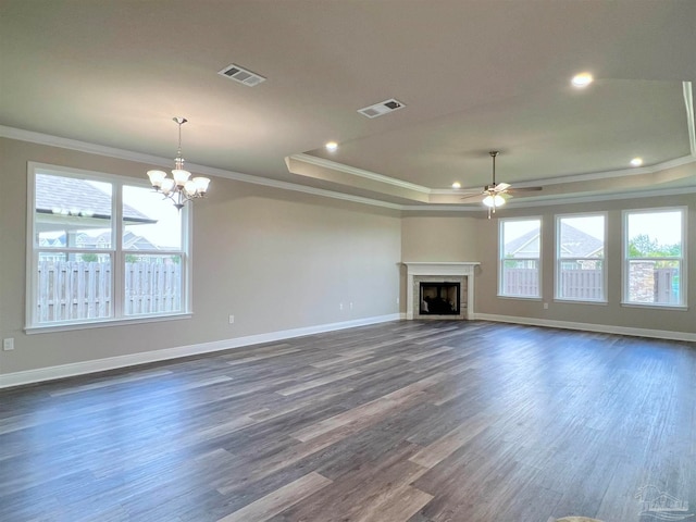 unfurnished living room featuring dark hardwood / wood-style floors, crown molding, and a healthy amount of sunlight