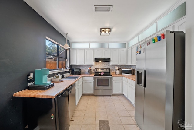 kitchen featuring white cabinets, light tile patterned floors, sink, and appliances with stainless steel finishes