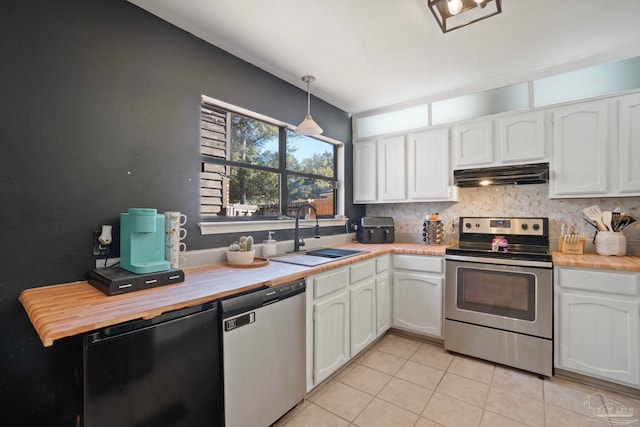 kitchen featuring hanging light fixtures, sink, white cabinets, and stainless steel appliances