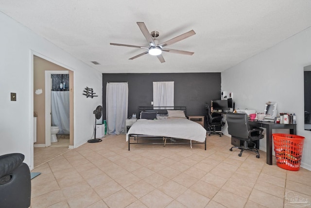 bedroom with ceiling fan and a textured ceiling