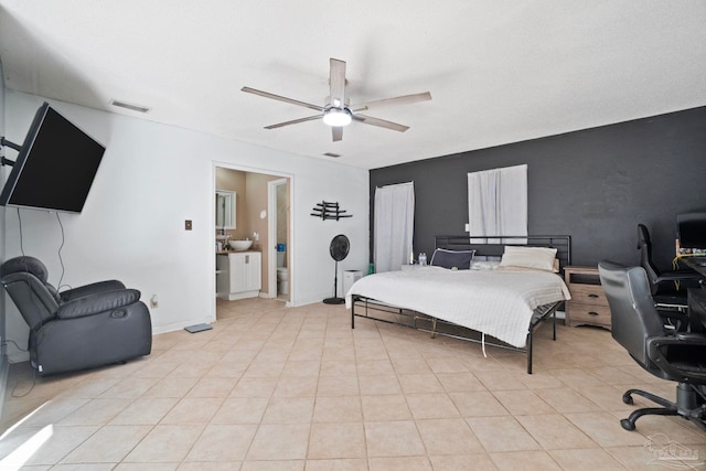 bedroom with light tile patterned floors, connected bathroom, and ceiling fan