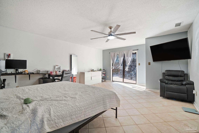 bedroom with access to outside, ceiling fan, light tile patterned flooring, and a textured ceiling