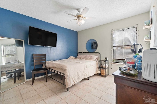 tiled bedroom featuring a textured ceiling and ceiling fan