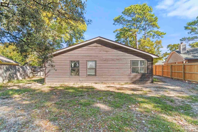 rear view of property with a lawn