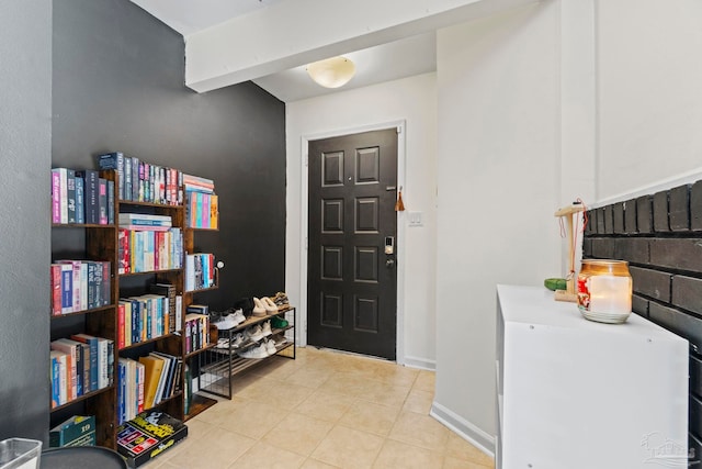 foyer entrance featuring beam ceiling