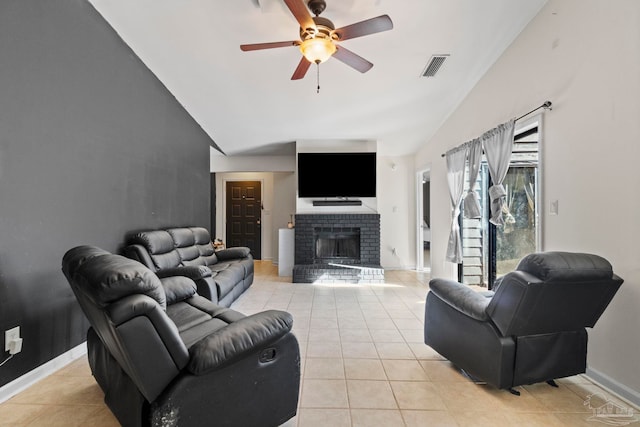 living room with a fireplace, light tile patterned floors, ceiling fan, and lofted ceiling