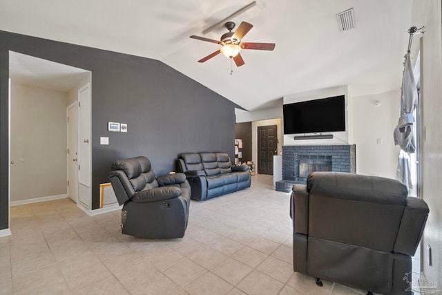 tiled living room featuring ceiling fan, vaulted ceiling, and a brick fireplace