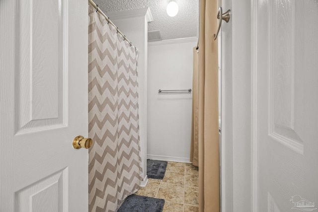 full bath with visible vents, curtained shower, a textured ceiling, crown molding, and tile patterned flooring