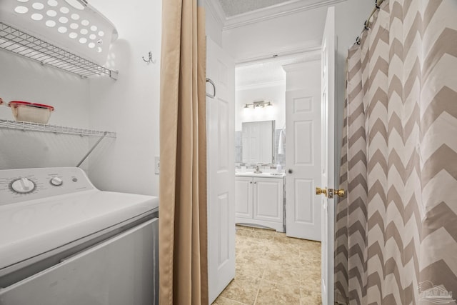 washroom featuring light tile patterned floors, washer / dryer, and crown molding