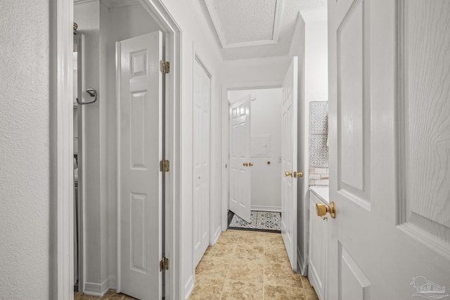 corridor with a textured ceiling