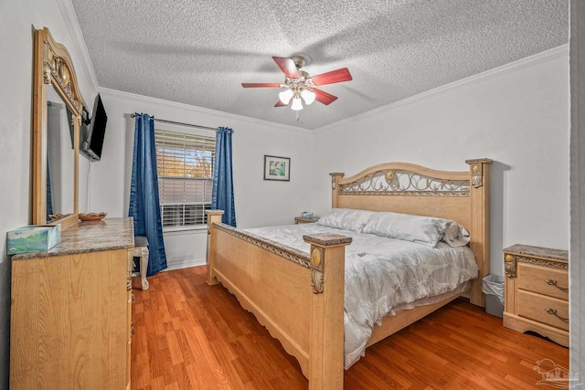 bedroom with ceiling fan, a textured ceiling, light wood-style flooring, and ornamental molding