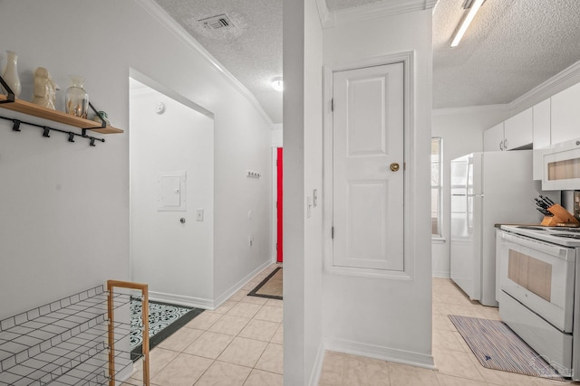 kitchen featuring visible vents, ornamental molding, a textured ceiling, white cabinetry, and white appliances