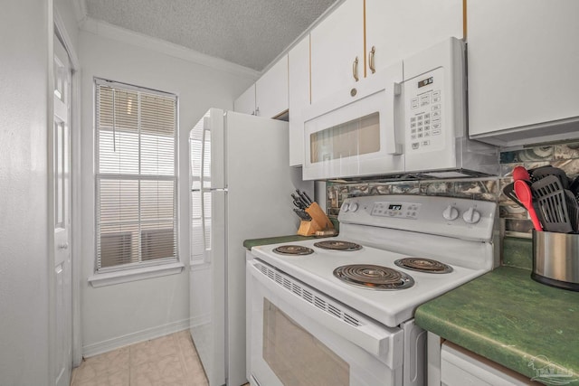 kitchen featuring white appliances, a textured ceiling, white cabinets, and crown molding