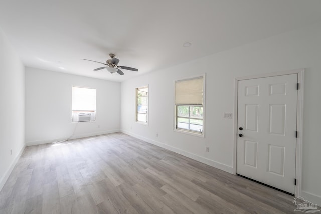 empty room with light hardwood / wood-style flooring and ceiling fan