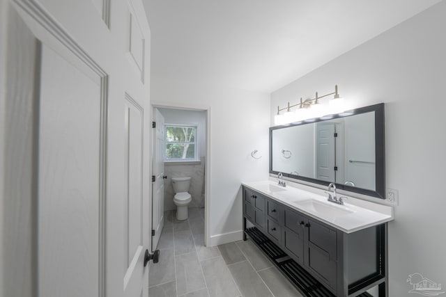 bathroom with vanity, tile patterned floors, and toilet