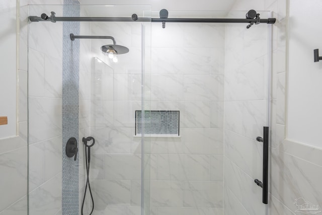 bathroom featuring a shower with door