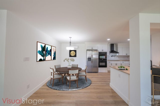 dining space featuring light wood-type flooring