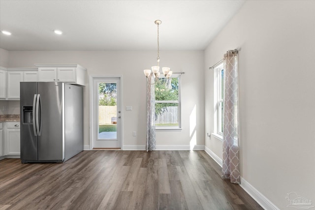 kitchen featuring white cabinetry, hanging light fixtures, dark hardwood / wood-style floors, stainless steel refrigerator with ice dispenser, and a notable chandelier