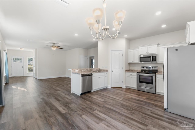 kitchen with white cabinetry, dark hardwood / wood-style floors, and appliances with stainless steel finishes