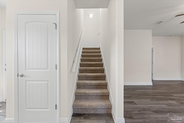 staircase featuring hardwood / wood-style floors