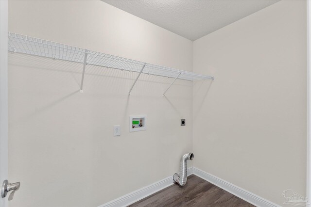 washroom featuring electric dryer hookup, hookup for a washing machine, dark wood-type flooring, and a textured ceiling