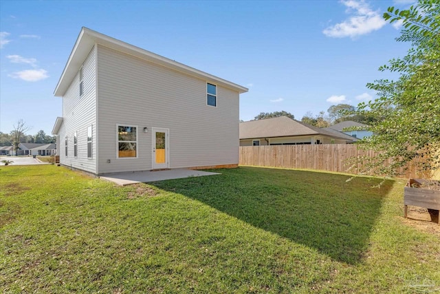 back of property featuring a lawn and a patio