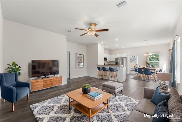 living room featuring ceiling fan and dark wood-type flooring