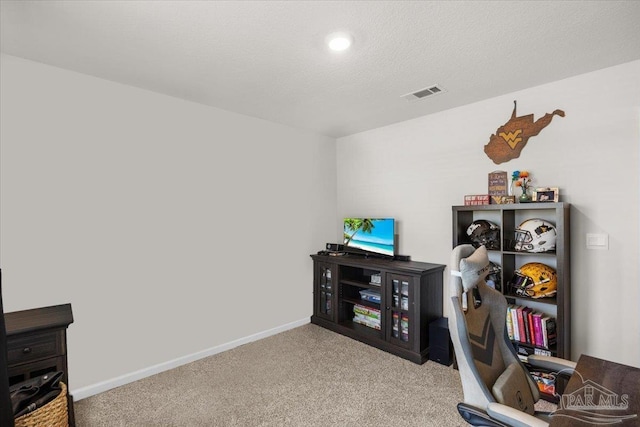 office space featuring baseboards, visible vents, and carpet