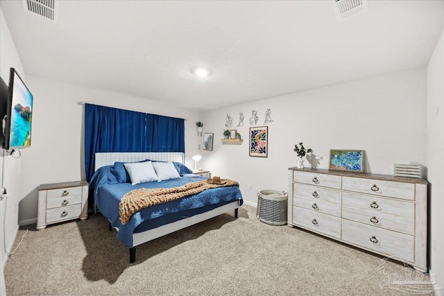 carpeted bedroom with baseboards and visible vents