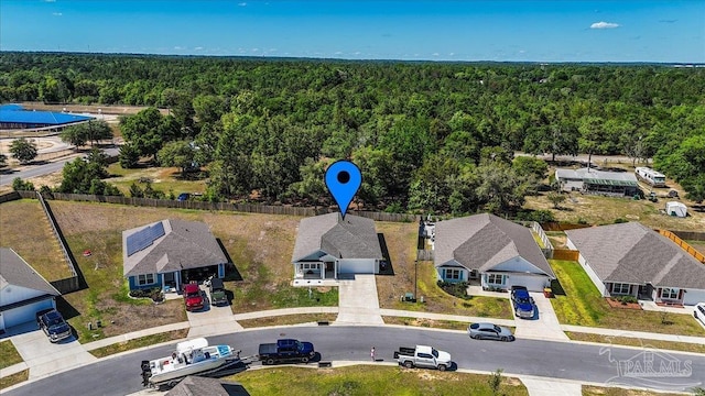 birds eye view of property with a forest view and a residential view