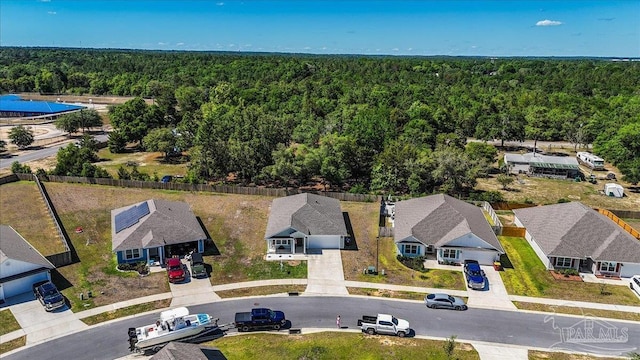 birds eye view of property with a wooded view and a residential view